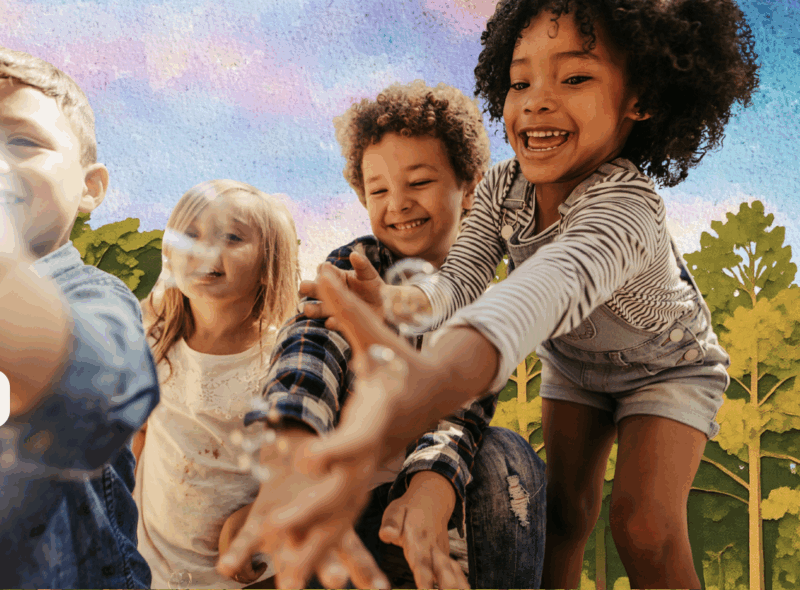 children play by the painted backdrop